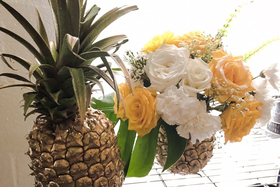 Golden Pineapple Flower Centerpieces. Destination wedding Hawaii. Design and decor provided by Bella amour events. Yellow, white