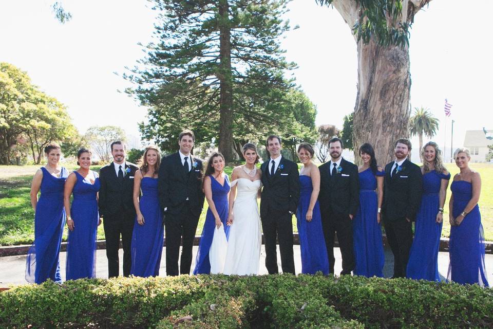 The bride, groom and bridal party out on the lawn