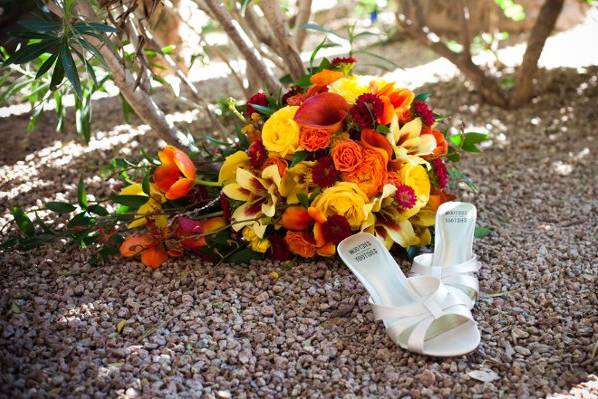 Romantic candles float over submerged red petals in the table centerpieces.