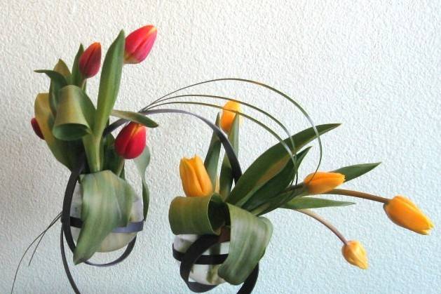 Tulips are creatively designed in an artistic metal/concrete/glass vessel. A perfect centerpiece in an urban setting, or for a creative/artsy couple. Also can greet guests as they arrive, near a sign-in area or under a message tree.