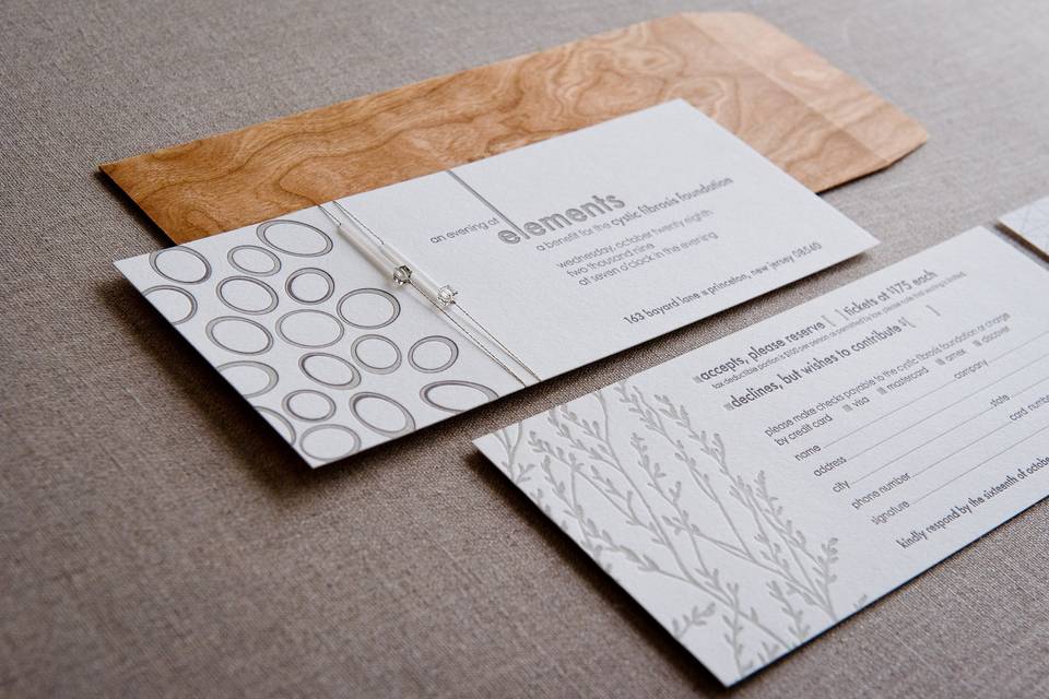 Letterpress printed event invitation. Embellished with crystals and silver floss. Fitted into natural wood grain envelope.