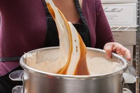 Creating salted caramel marshmallows - folding our soft honey caramel into vanilla bean marshmallow.