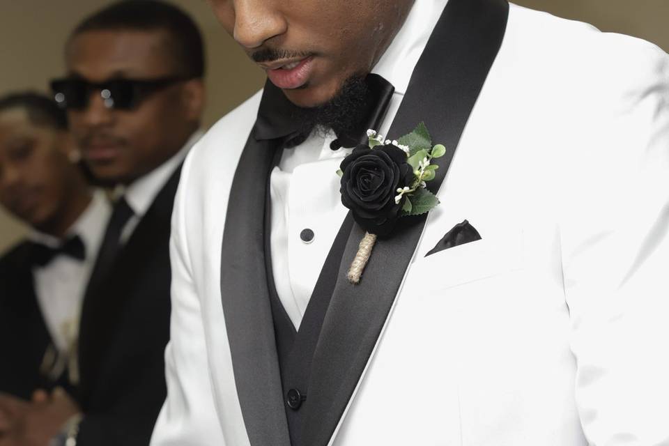 Close-up of groom in white tux