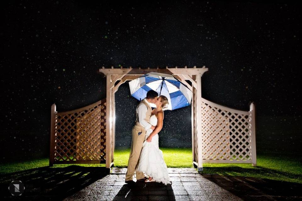 Bride and groom in rain