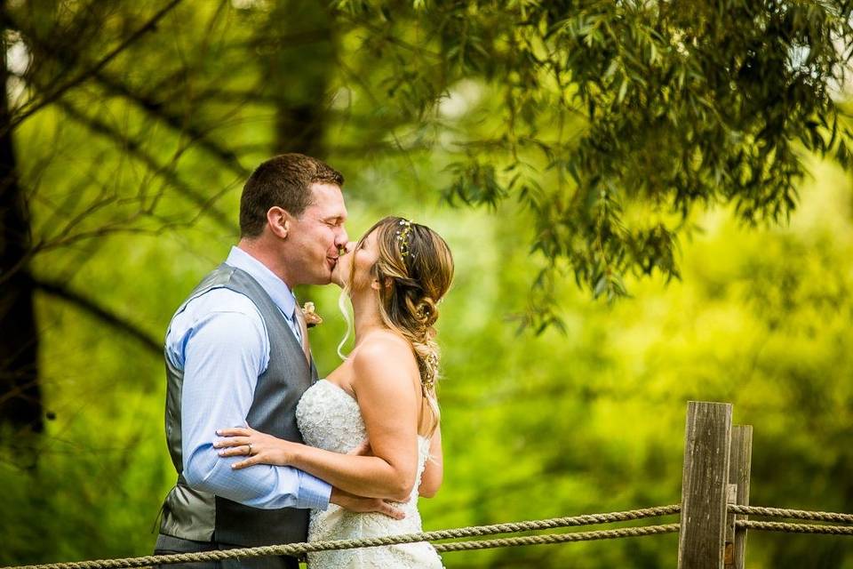 Bride and groom under trees