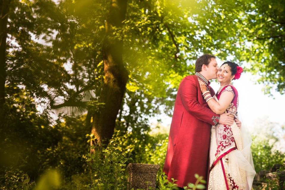 Bride and groom under trees