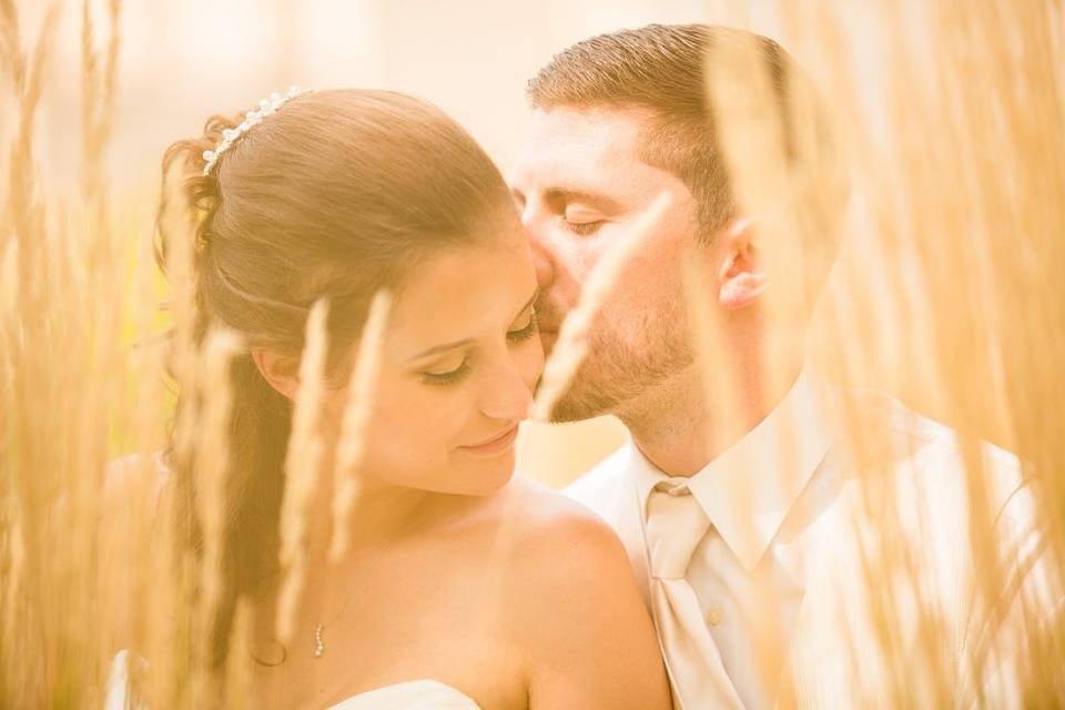 Bride and groom in tall grass