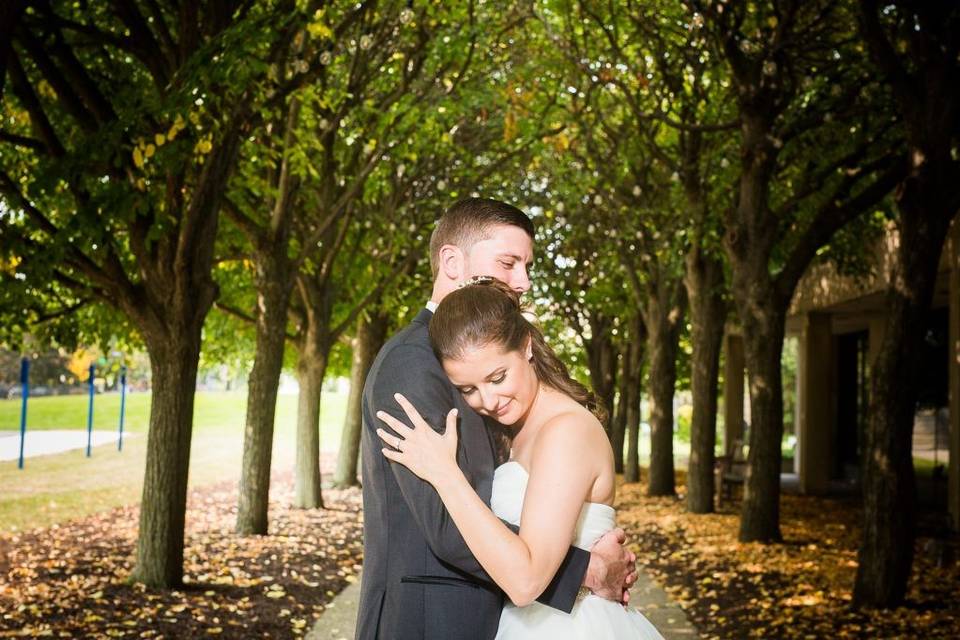 Bride and groom under trees