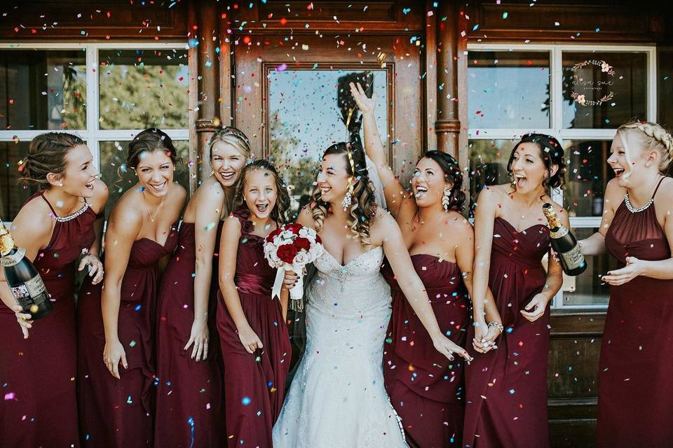 Bride and her bridesmaids throwing rice