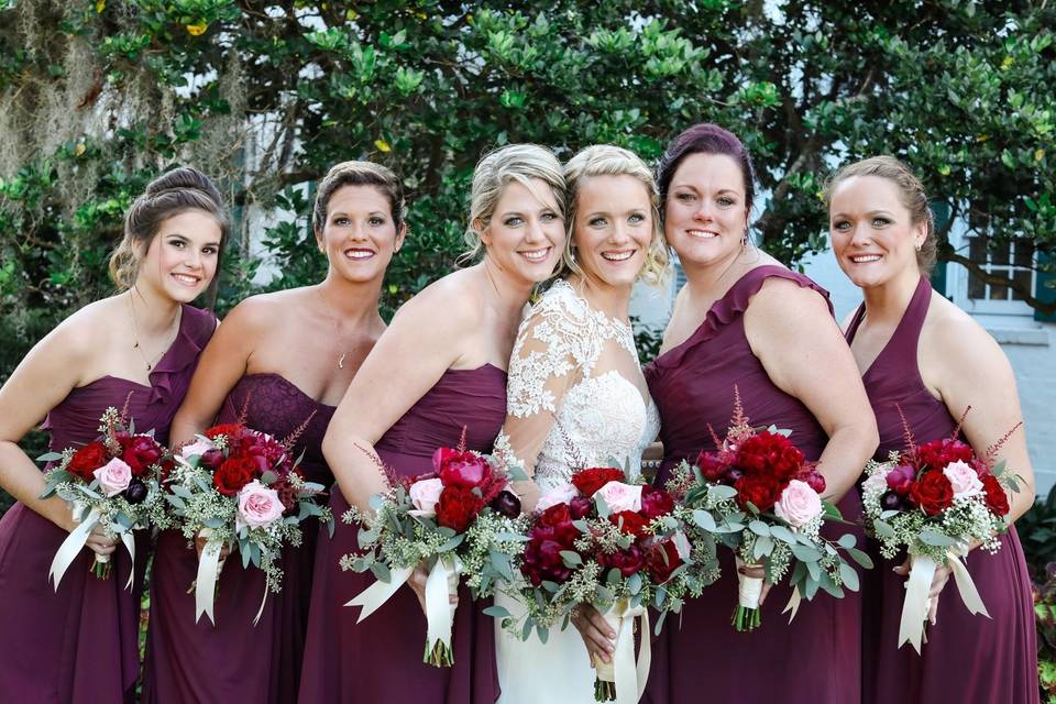 The bride holding her bouquet with her bridesmaid