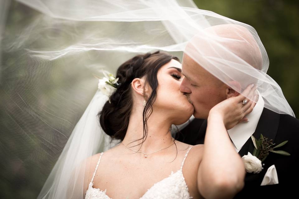 Bride and Groom Under Veil