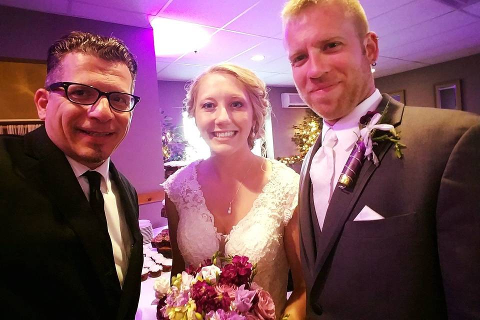 With the officiant and the newlyweds