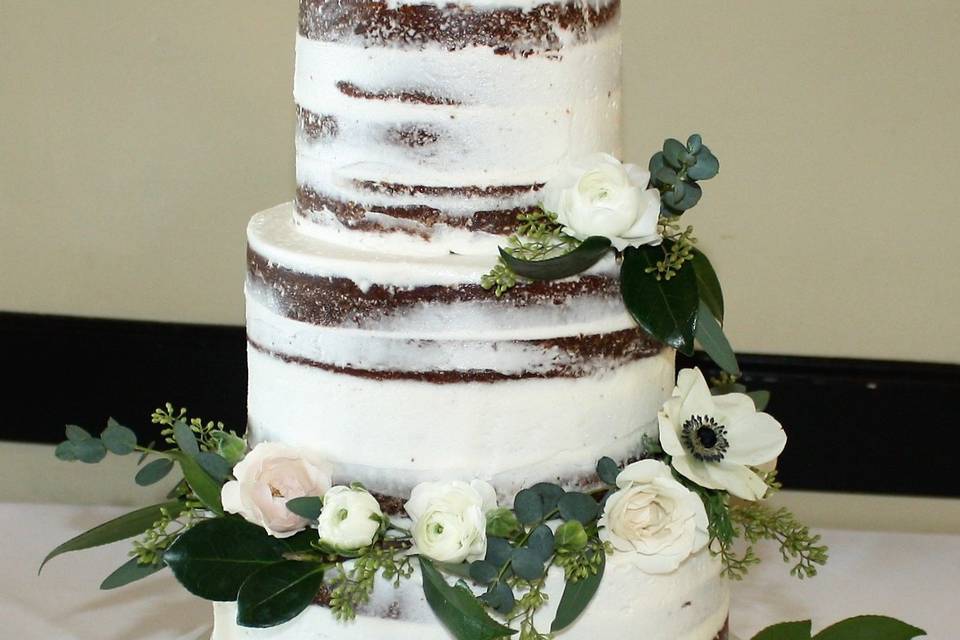 Naked wedding cake with white flowers