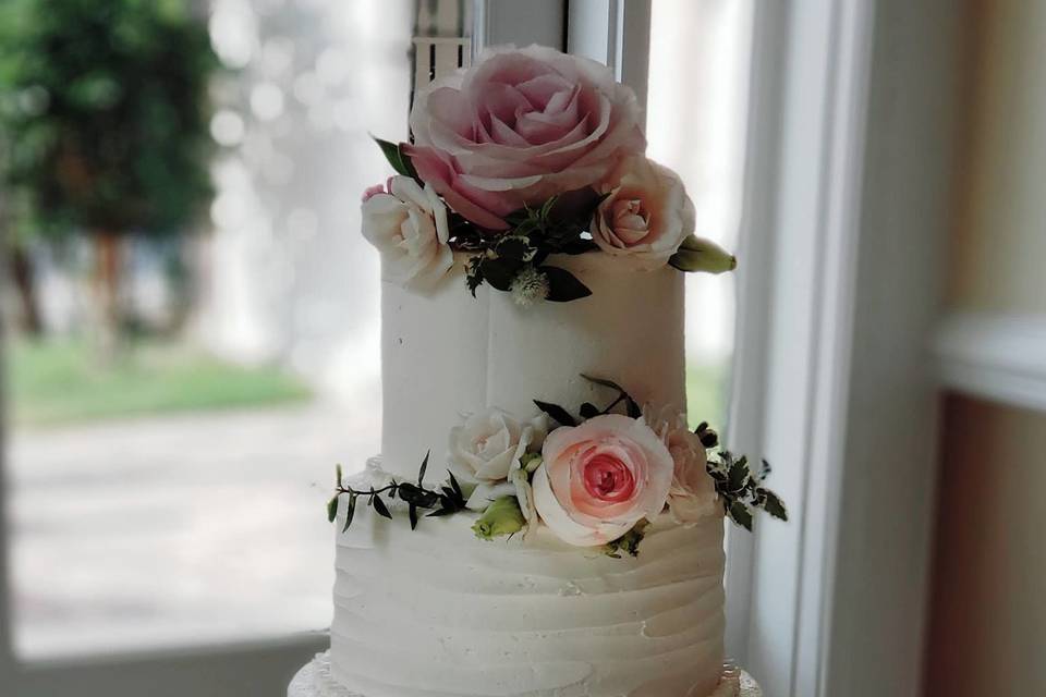 White wedding cake with soft pink flowers