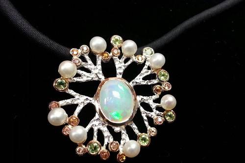This beautiful Opal, Pearl, and Garnet pendant is just one of many one-of-a-kind pieces in our store! If you have a dream, Whidbey Jeweler can make it!