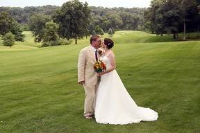 Wedding Kiss with lush greens as background.