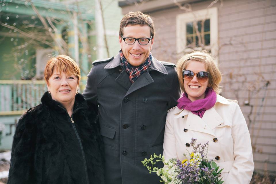 Officiant with the groom and bride