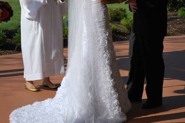 Bride and groom listening to officiant