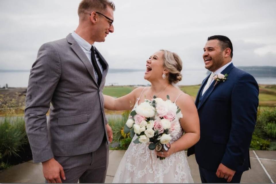 Couple laughing with officiant