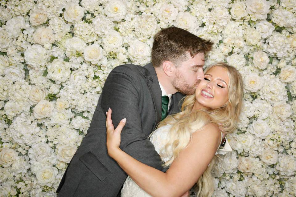 Bride and groom and flower wal