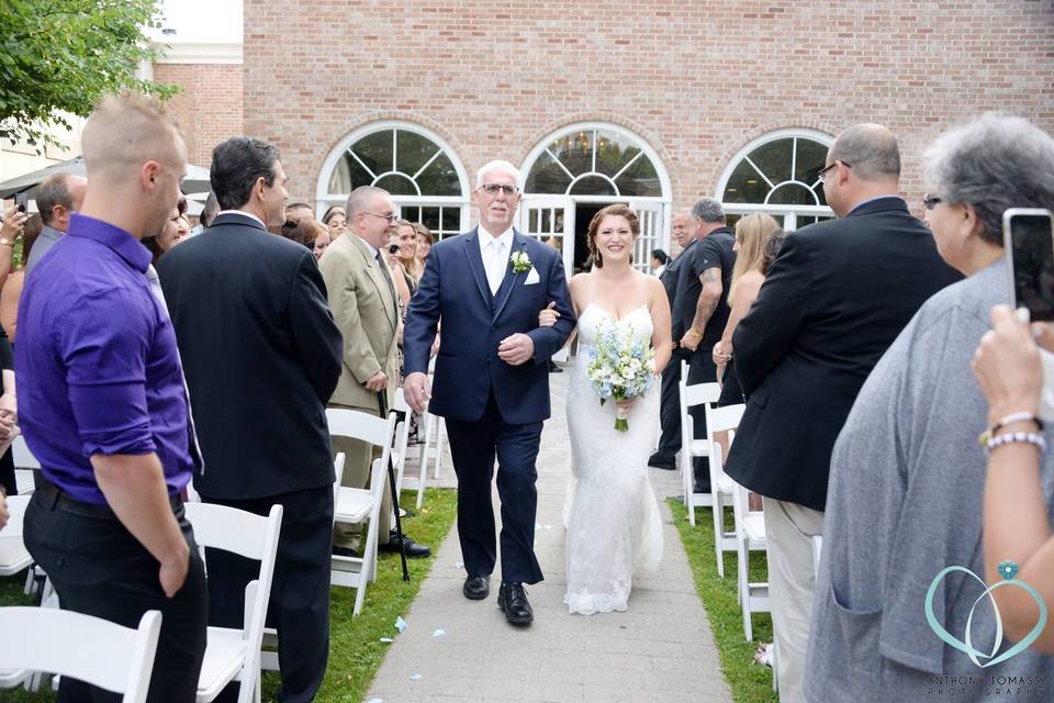 Newlyweds and their guests by the gazebo