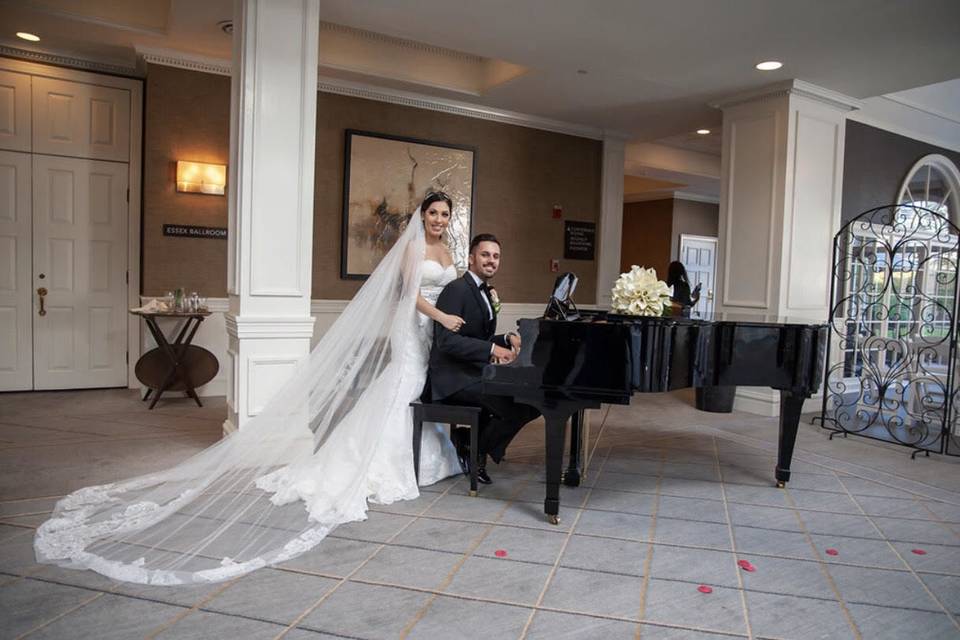 Newlyweds by the grand piano