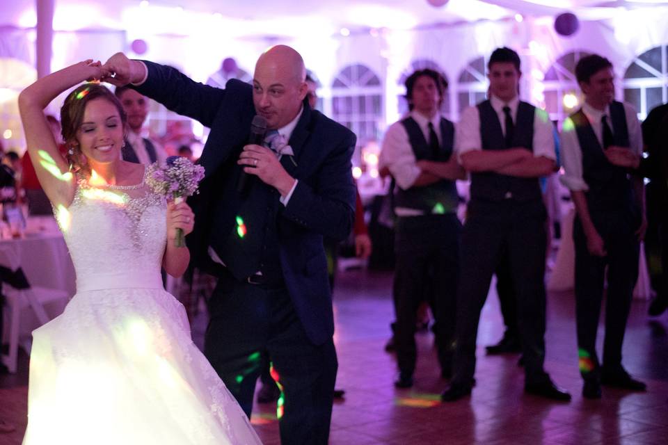 Mike bell dancing with the bride as he performs as host/mc and wedding reception dj