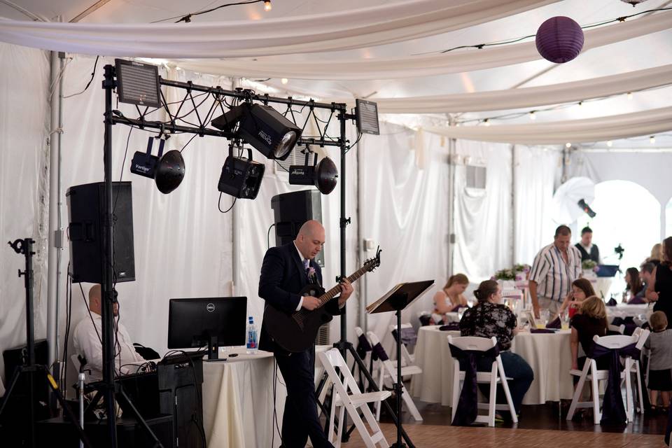 Mike bell performing cocktail hour live music on guitar in front of his dance floor lighting and pa system set up