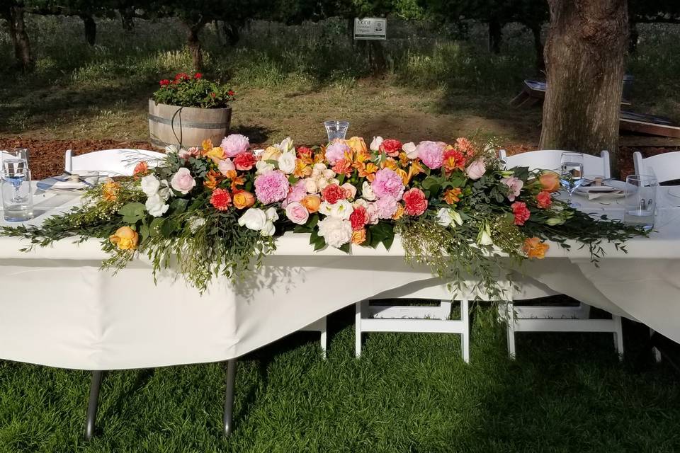 Head table with bright flowers