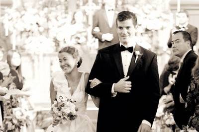 The newly wed couple smile at friends during their recessional.