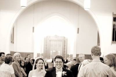 A high five from a friend makes the couple grin during their recessional.