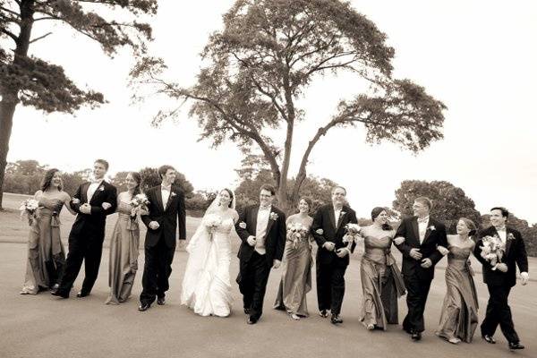 The wedding party talks and laughs after the ceremony.