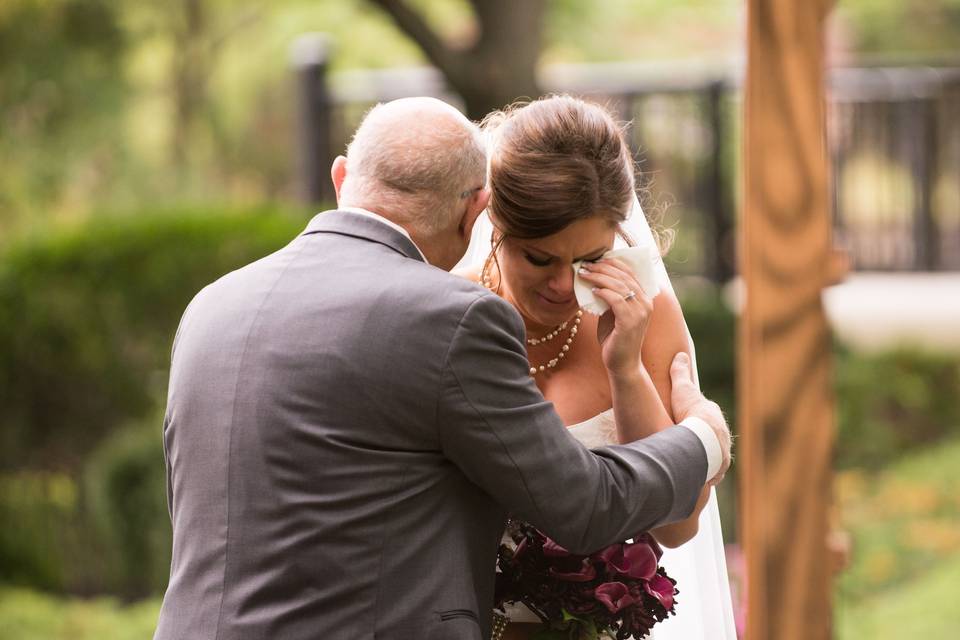 Bride comforted by father