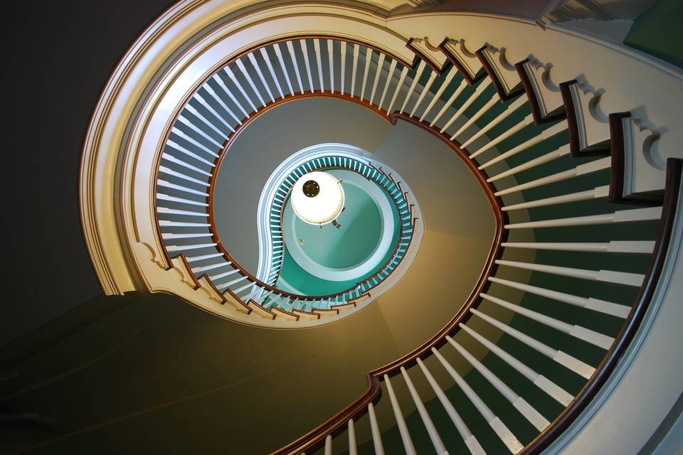 The three-story Spiral Staircase makes for amazing photo opportunities, nestled within the Historic McCune Mansion