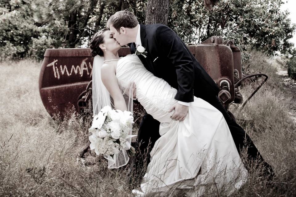 Groom dips his bride for a kiss