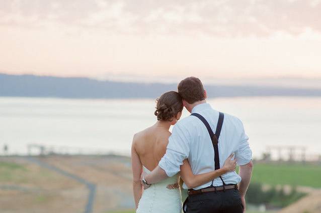 Newlyweds overlooking the field and sea