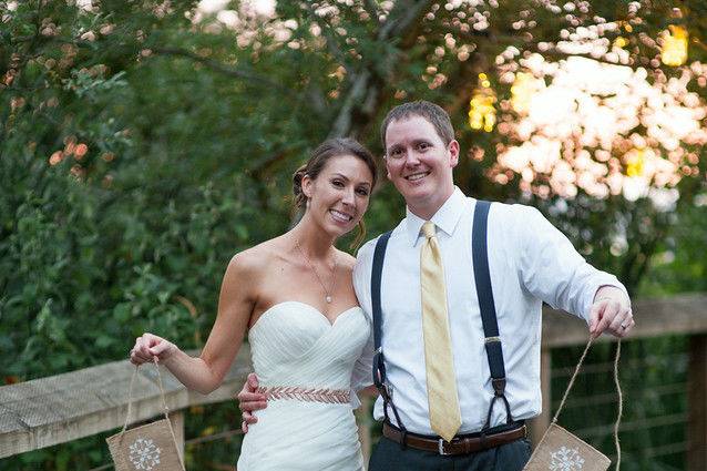 Bride and groom holding the sign