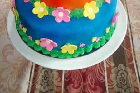 A three tier celebration, birthday, anniversary or wedding cake cover in marshmallow fondant.