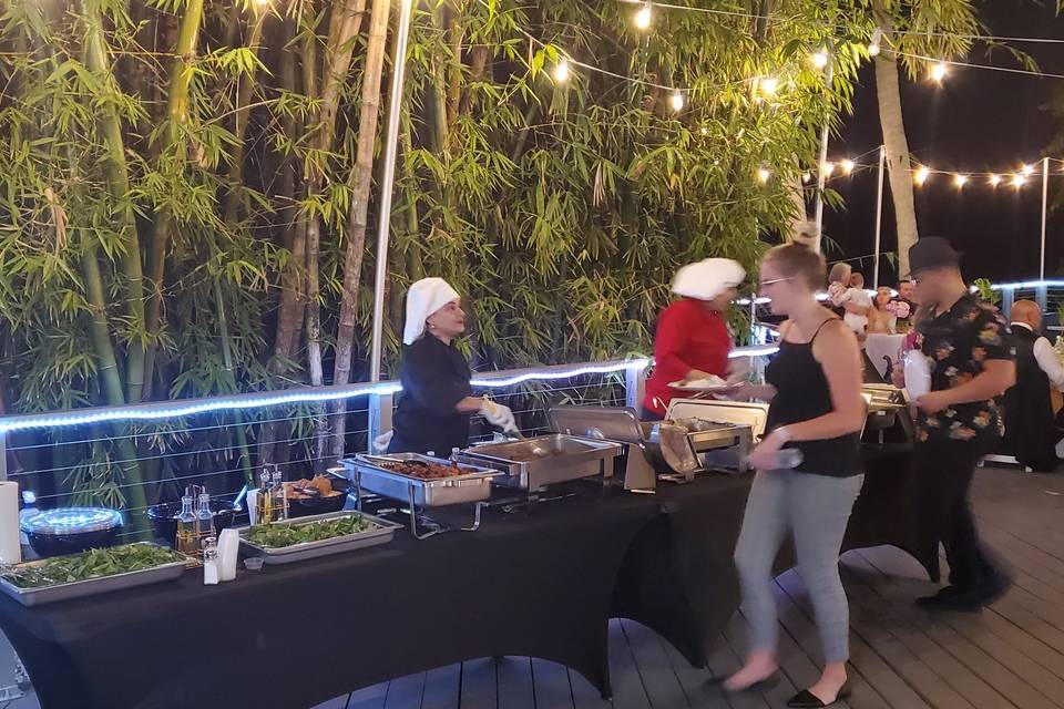 Buffet line in front of bamboo