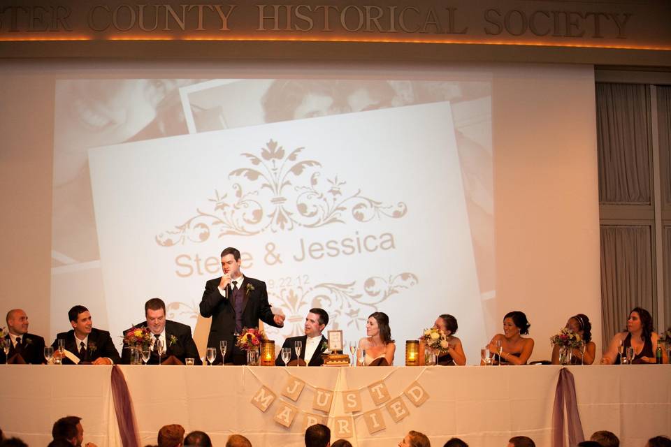 Bridal Party Table atop the stage in the CCHS AuditoriumPhoto Credit: Amy Tucker Photography, http://amytuckerphotography.com/