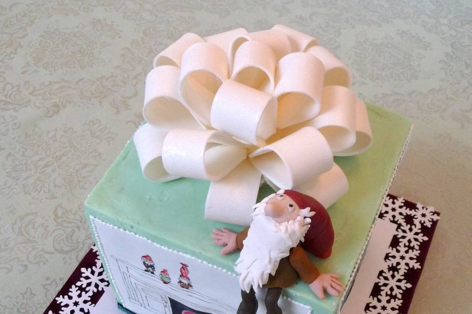Tomten theme Holiday Cake.  Coconut Cake with Bittersweet Chocolate Ganache filline and covered in White Chocolate Ganache.  Little troll is sugar paste.