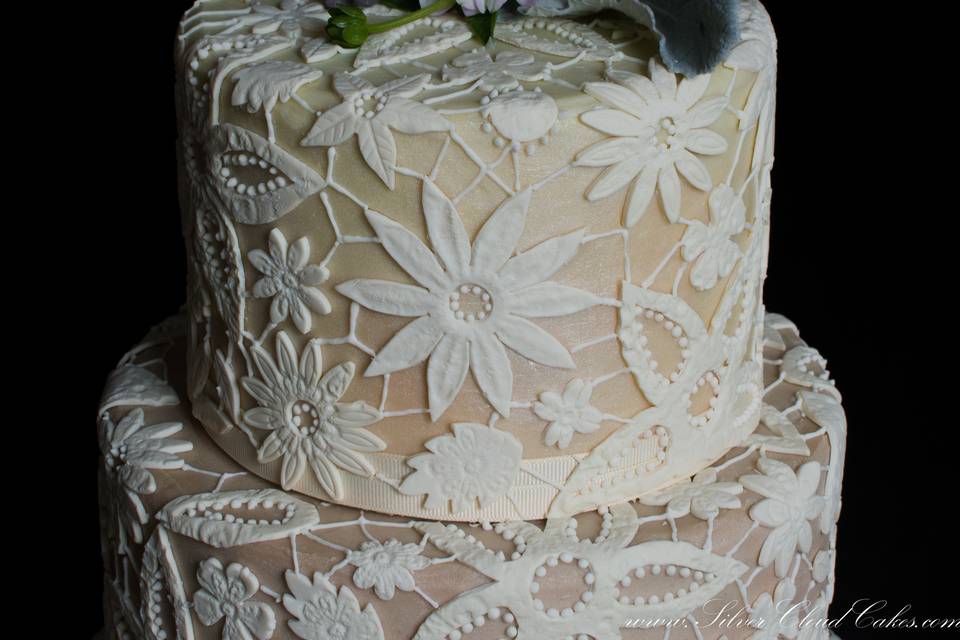 Handcrafted White Chocolate Guipere Lace covers this Ganache Wedding Cake.