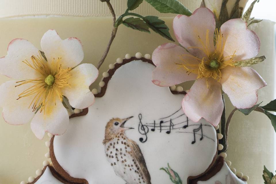 Handpainted tile cookies look like fine porcelein on this musical theme wedding cake.