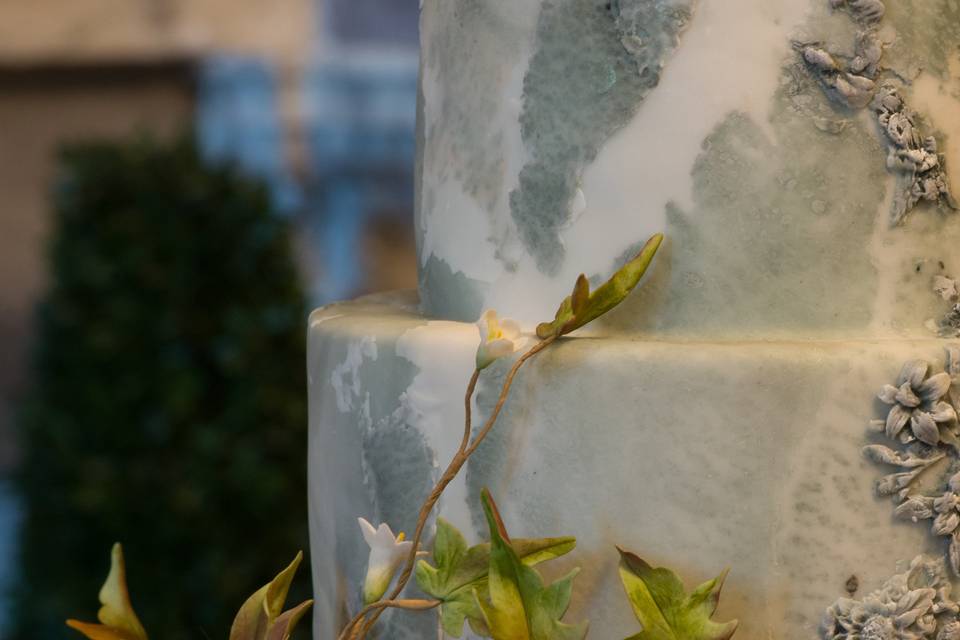 Handcrafted sugar flowers and a marble look wedding cake.