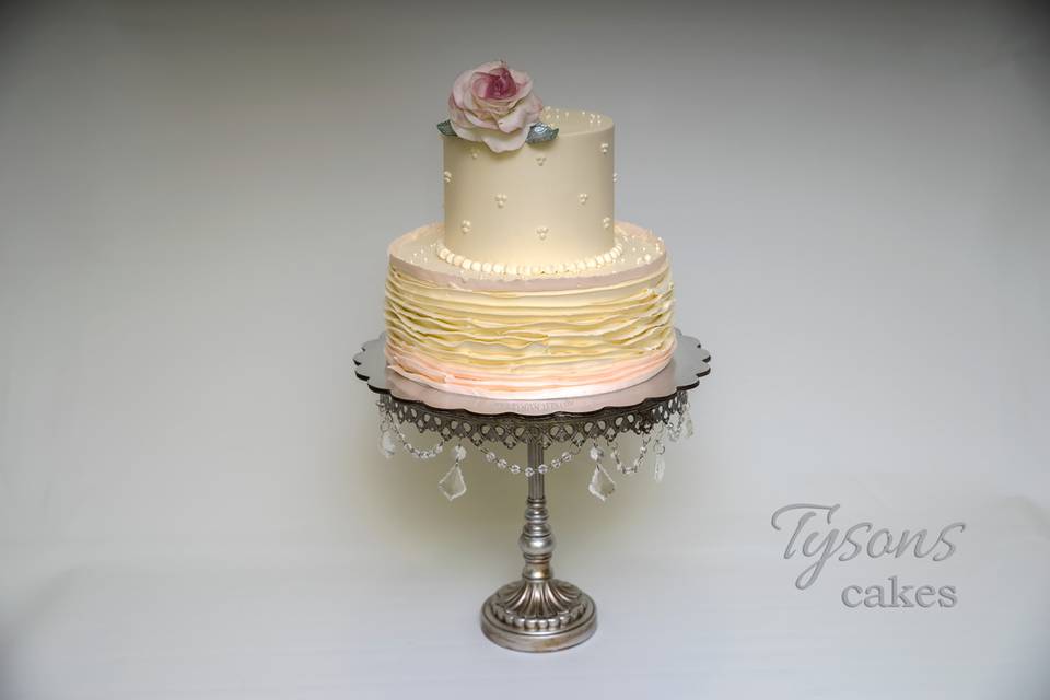 Two tier cake with a flower on top