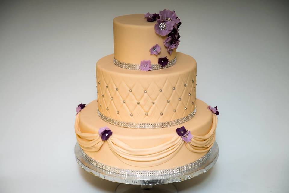 Three tier purple and peach cake