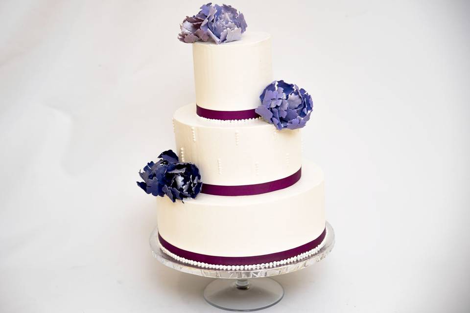 Three tier cake with purple lining