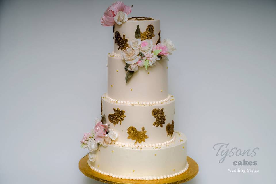 Four tier white and gold cake