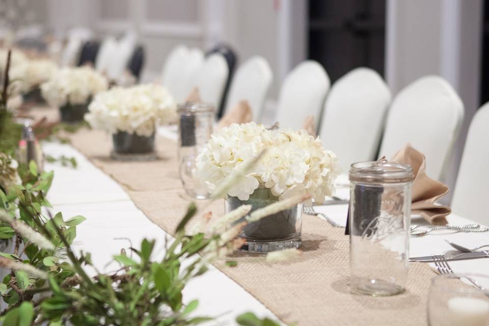 Floral centerpieces and beige table runner