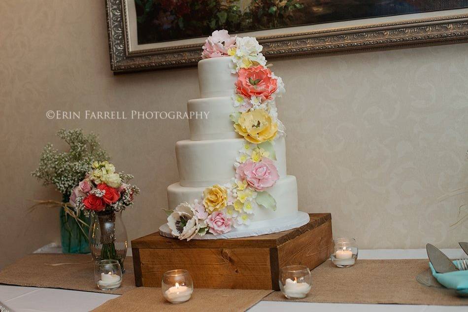 Beautiful sugar flowers cascading down a marshmallow fondant covered cake